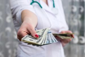doctor physician hands giving money closeup: © RomanR - stock.adobe.com