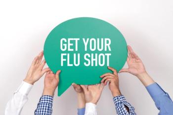 hands holding sign encouraging flu shot