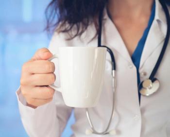physician holding morning coffee: © batuhan toker - stock.adobe.com