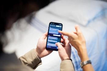 Researcher demonstrates the BrainChat app on a smartphone | Image Credit: © Trustees of the University of Pennsylvania | Photo: Eric Sucar