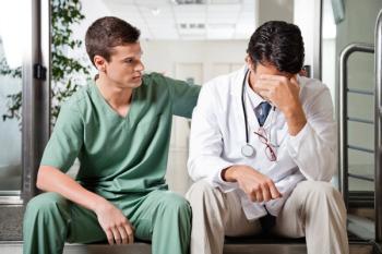 doctor comforting another doctor