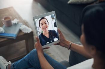 unrecognizable person over, view over left shoulder, holding tablet with someone who looks like healthcare professional | ©JeffBergen/peopleimages.com  stock.adobe.com