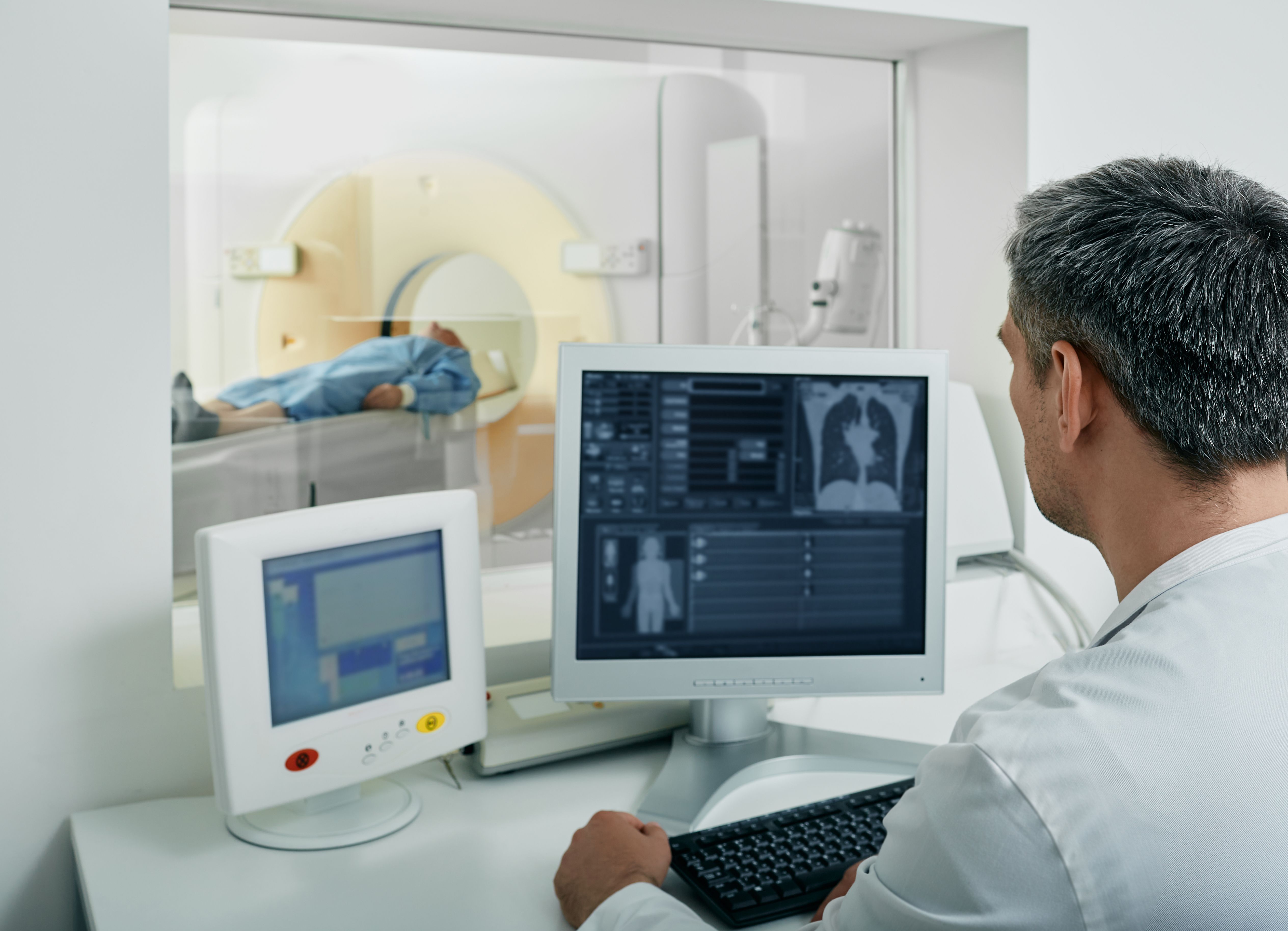 technician looking at patient getting CT scan of lungs | image credit: ©peakstock stock.adobe.com