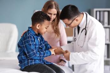 Doctor examining Black boy's skin | Image credit: Pixel-Shot - stock.adobe.com
