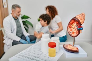 boy and mom speaking with HCP with a model of a kidney in the foreground | image credit: ©Peakstock stock.adobee.com