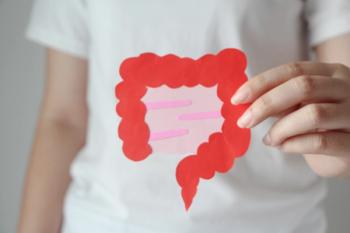 hand holding intestine shape that is the color pink | Image credit: © jajam_e  stock-adobe.com
