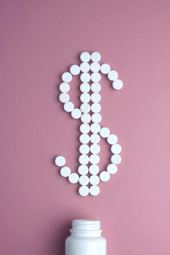 dollar sign on pink background, spelled out using pills | image credit:Людмила Короткова stock.adoble.com