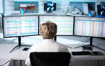 Person looking at screens with coding | Image credit: @Andrey Popov stock.adobe.com