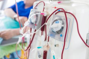 dialysis machine w patient in the background wearing blue | image credit: @Александр Ивасенко  stock.adobe.com