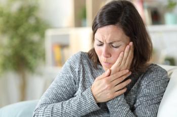 woman holding side of face with painful grimace | Image credit: ©Pheelingsmedia stock.adobe.com