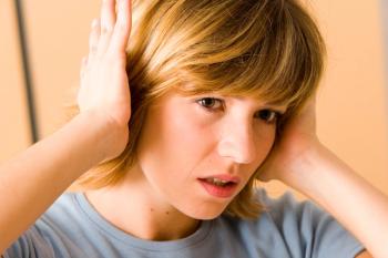 woman holding hands over her ears looking uncomfortable | Image credit: ©RFBSIP stock.adobe.com