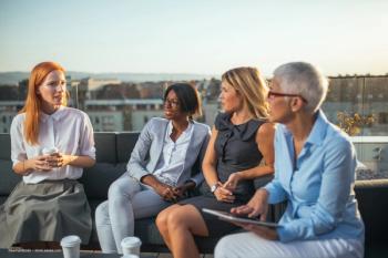 A group of women in business attire sit on a veranda, sharing coffee. Women in Retina Networking Breakfast concept image for EURETINA Congress. Image credit: ©bernardbodo – stock.adobe.com