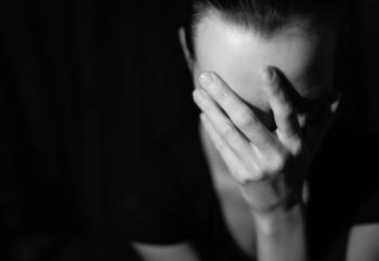 young woman distress sadness hand face