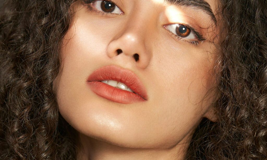close up of curly haired woman's lower face