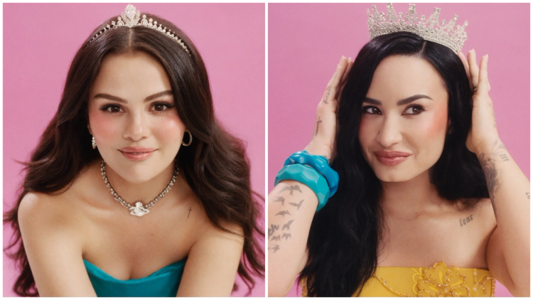 Selena Gomez and Demi Lovato wear tiaras and rosy blush against a pink backdrop.