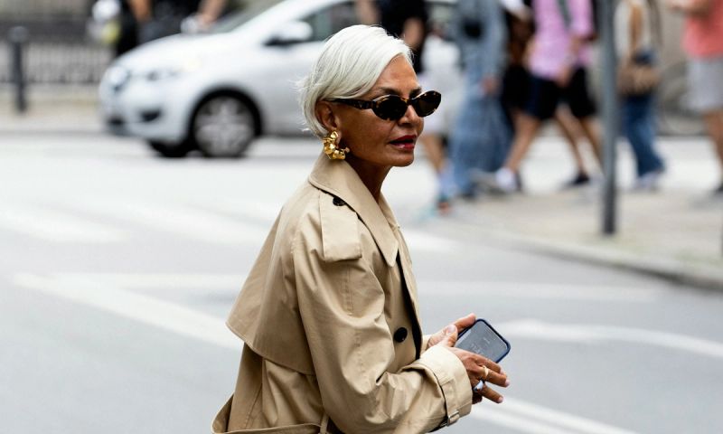 older woman in sunglasses walking city streets