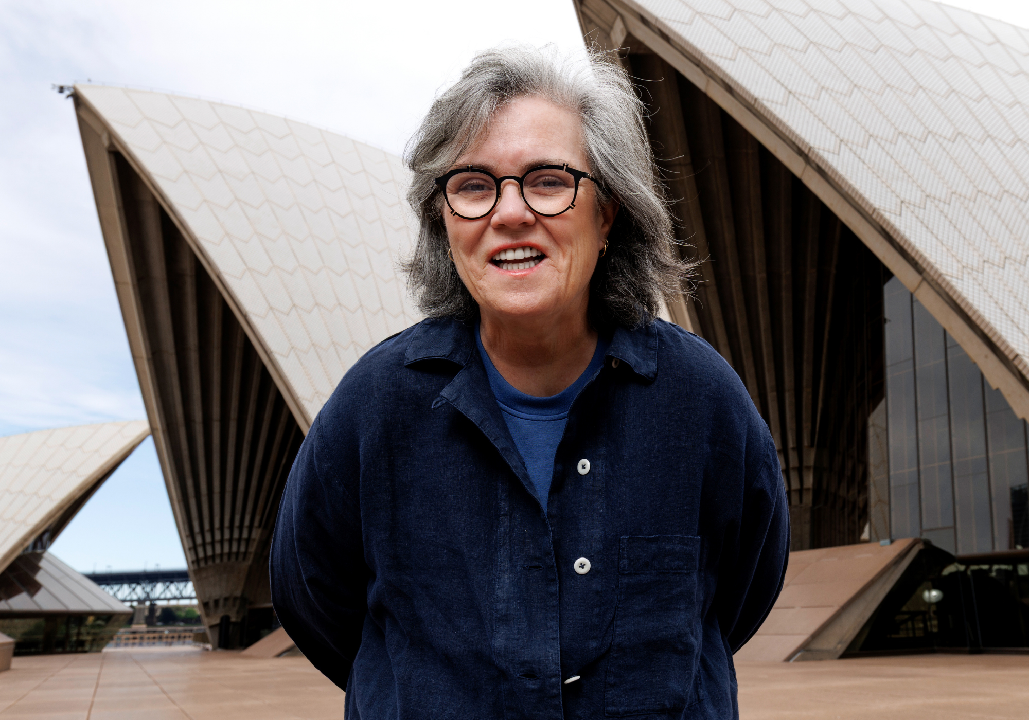 Rosie O’Donnell, who recently revealed she had a deep-plane facelift, poses in front of the Sydney Opera House.