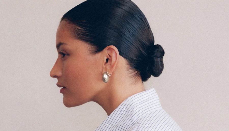 woman with a bun with crown affair the finishing spray