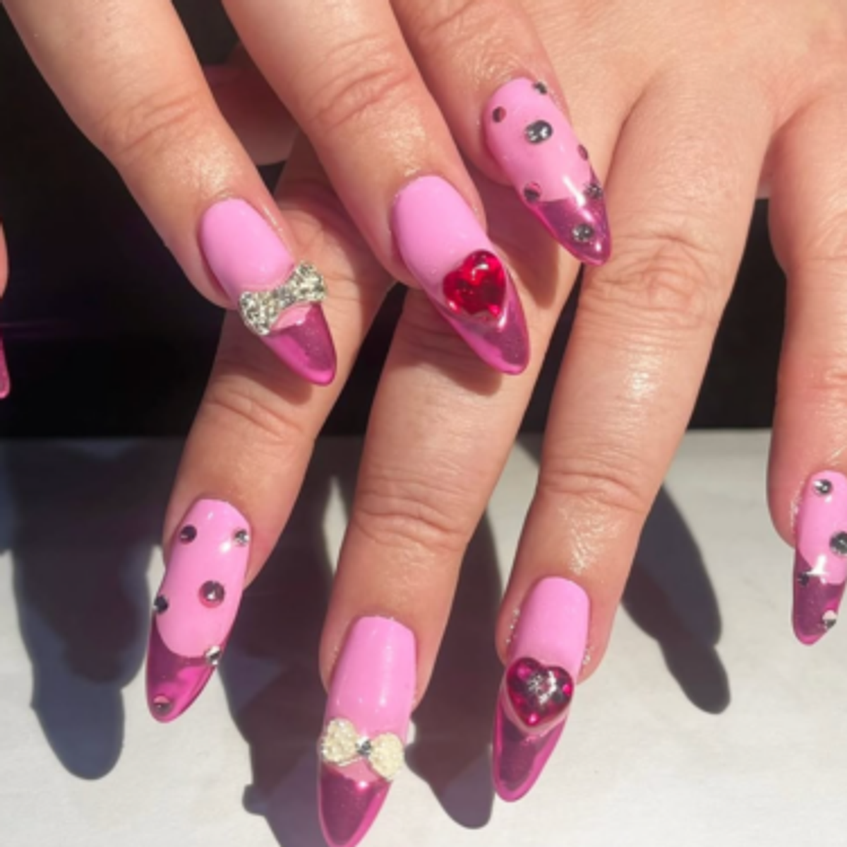 pink on pink nails with rhinestones and bows