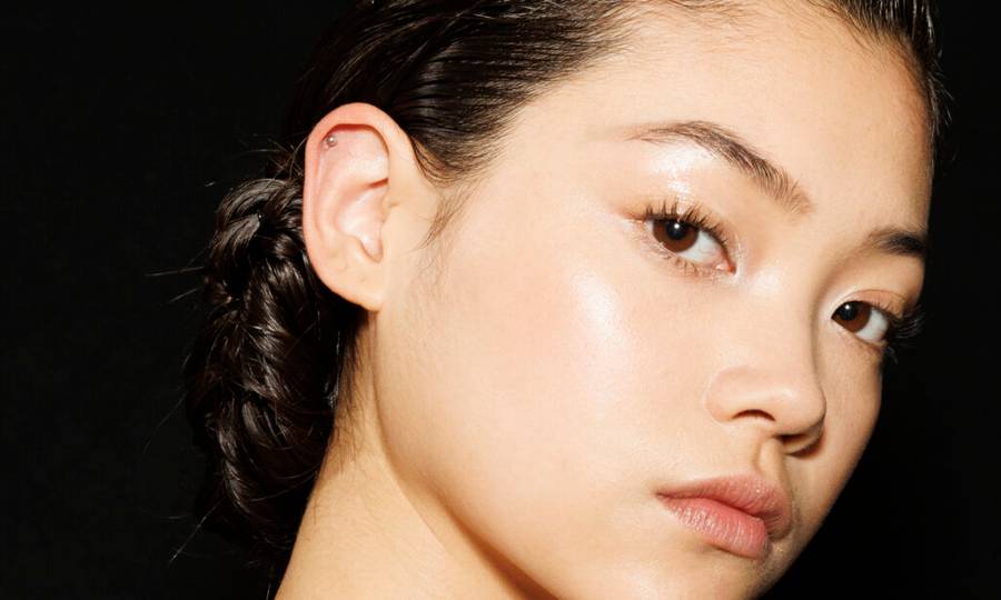 Up-close of Asian woman's face on a black background