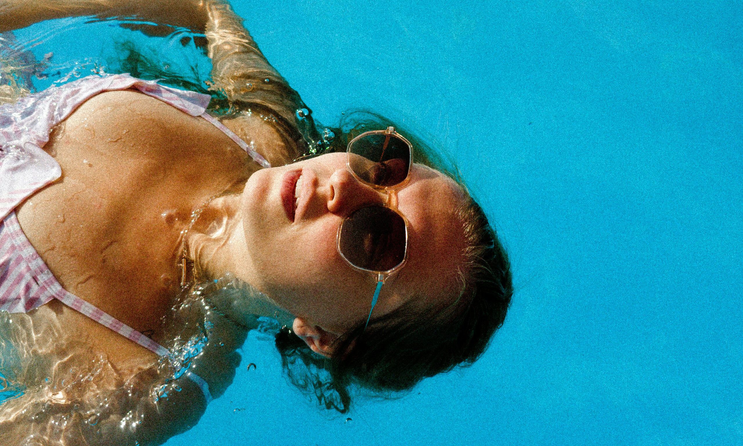 woman sunbathing in pool