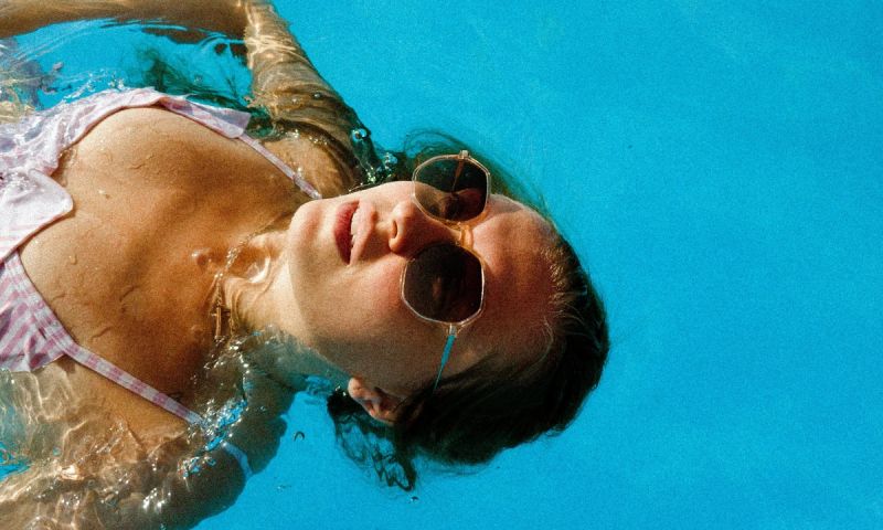 woman sunbathing in pool