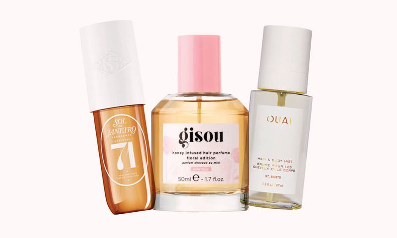 various hair mists on a light pink background