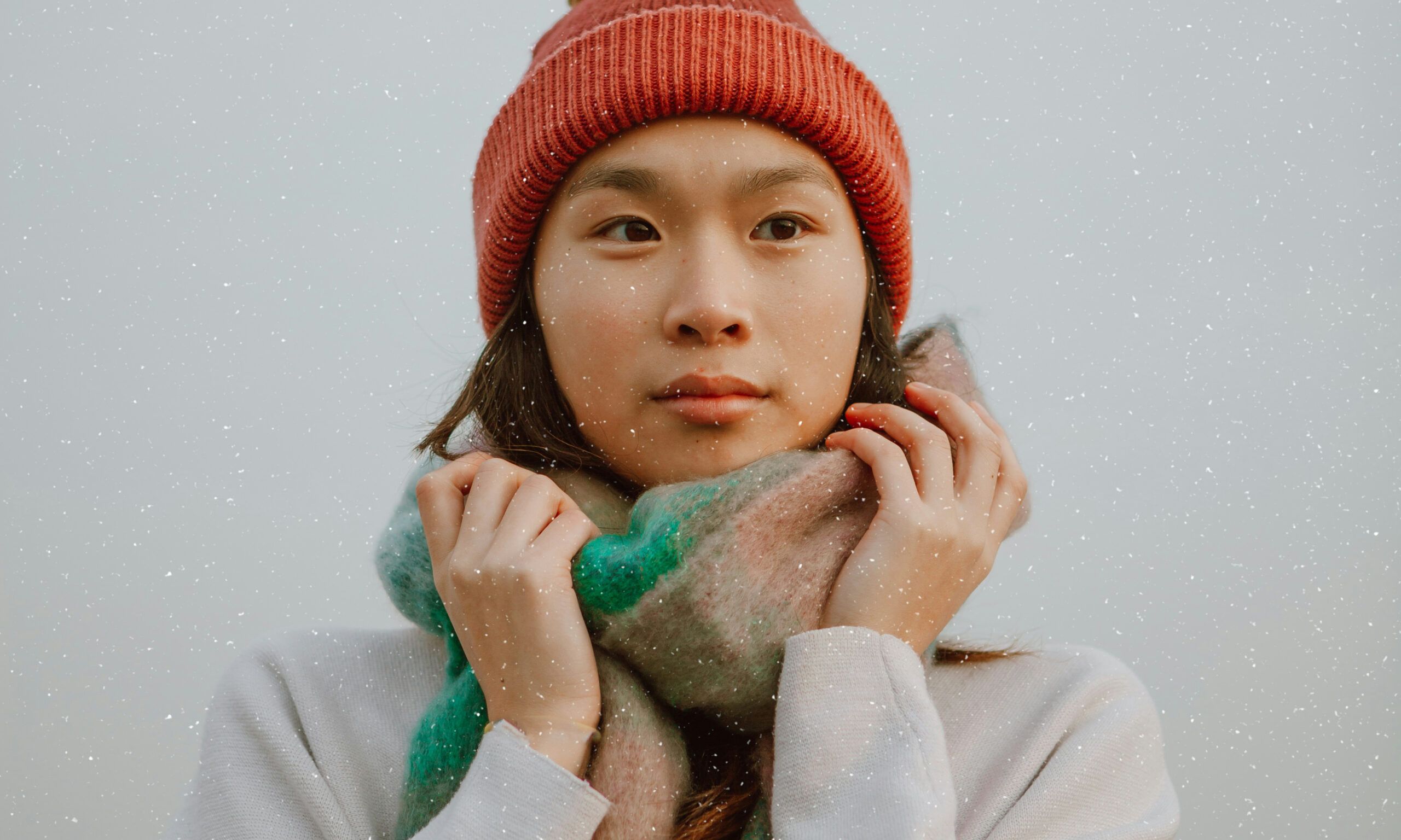 woman in snow holding scarf