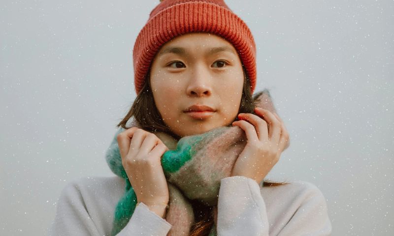 woman in snow holding scarf