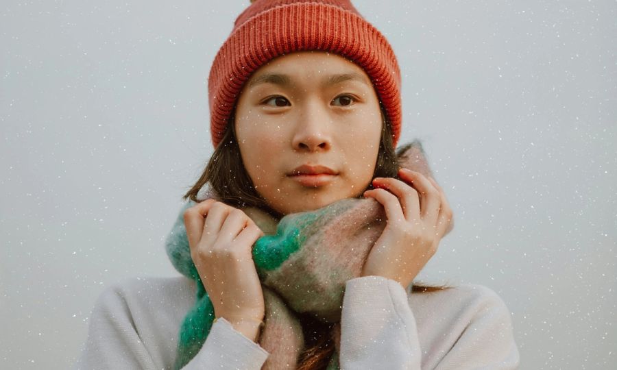 woman in snow holding scarf