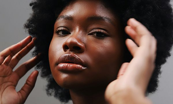 beautiful black woman with hands up near face