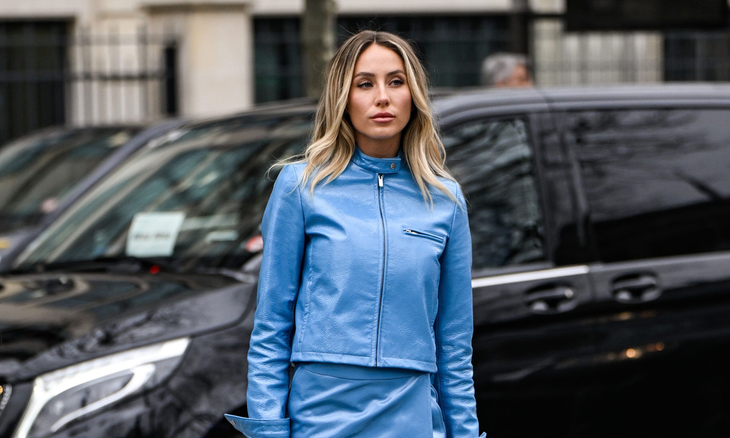 Alix Earle is seen wearing a blue Miu Miu jacket, blue Miu Miu skirt, white Miu Miu bag, gray Miu Miu socks and cream flats outside the Miu Miu show during the Womenswear Fall/Winter 2025/2026 as part of Paris Fashion Week on March 11, 2025 in Paris, France.