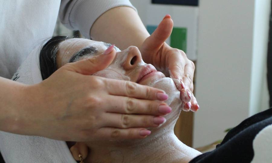 woman getting facial treatment at spa