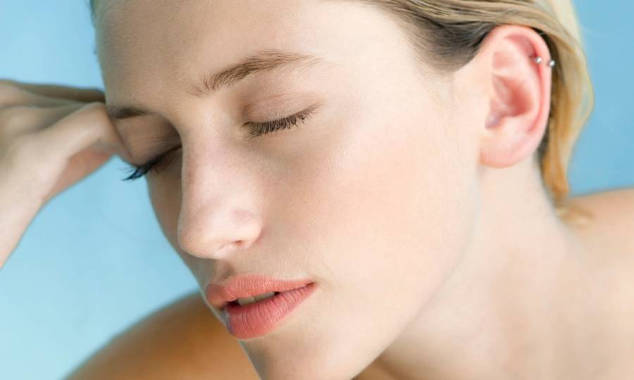 Woman relaxing in pool with eyes closed