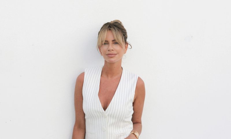 Caroline Stanbury in a white vest in front of white background