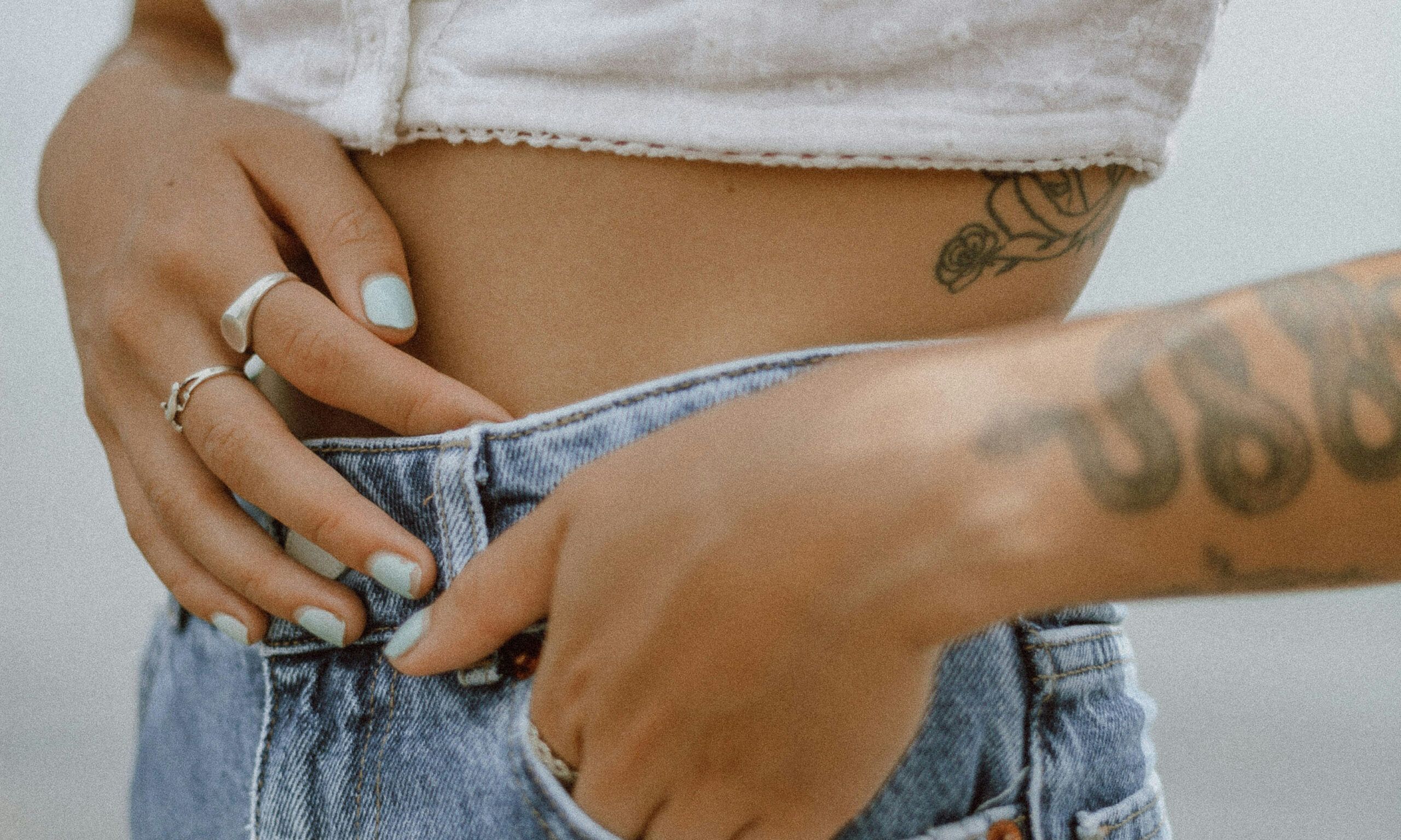 close up of woman's arms and hands on her waist
