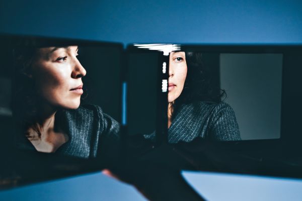 woman looking in mirror