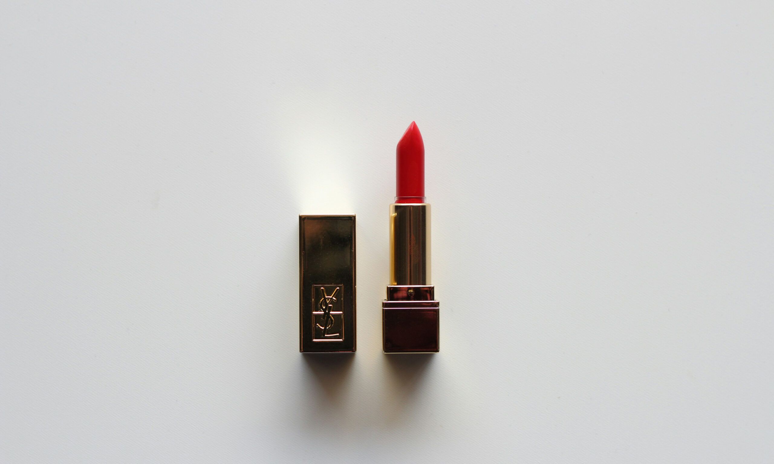 YSL red lipstick tube on gray background