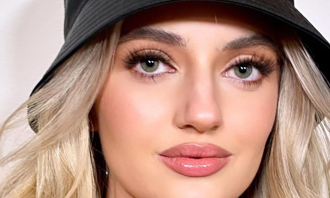 Close-up of blonde-haired woman's face wearing heavy makeup