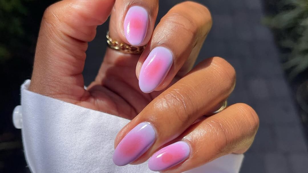 Hand with pastel aura nail design