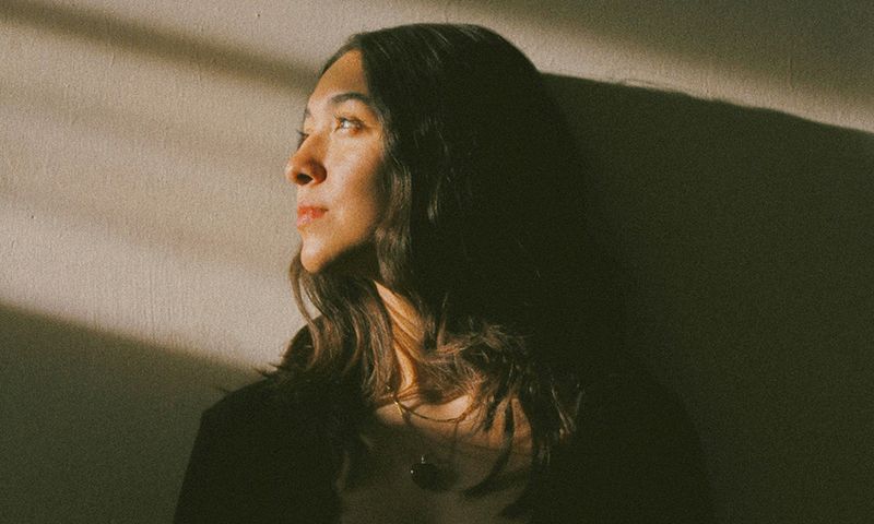 woman looking to the side in shadows