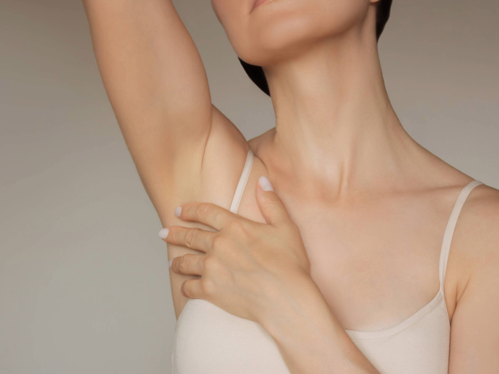 woman touching her underarm