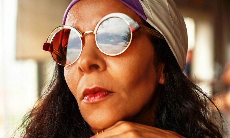 Mature woman's face with sunglasses and head scarf on