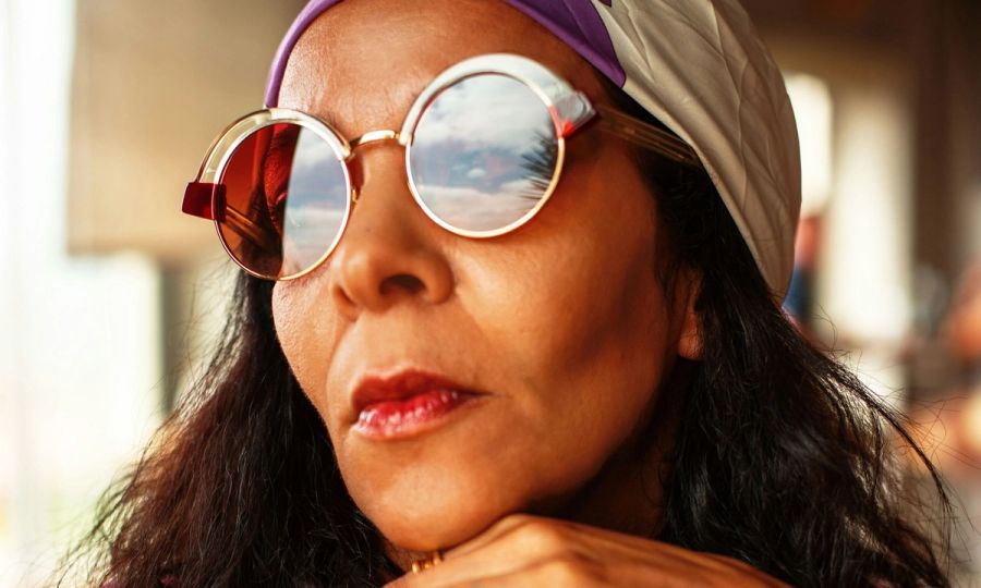 Mature woman's face with sunglasses and head scarf on