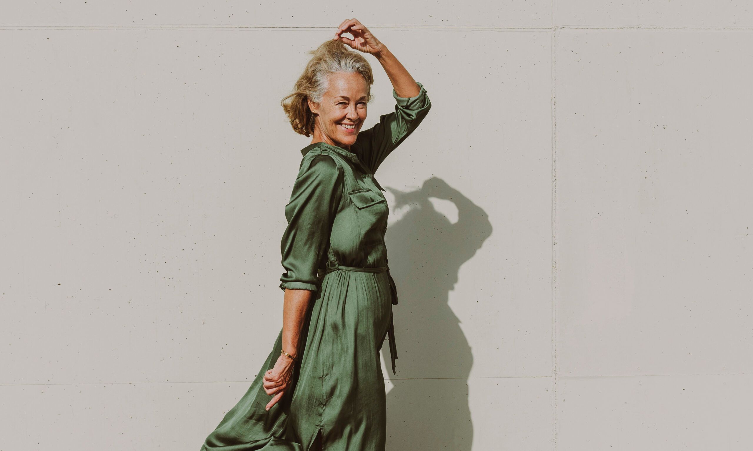 Smiling mature woman dancing on sunny day