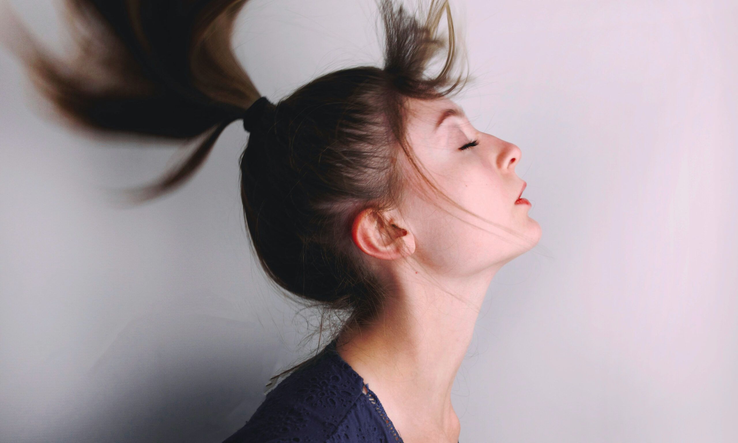Woman flipping over ponytail