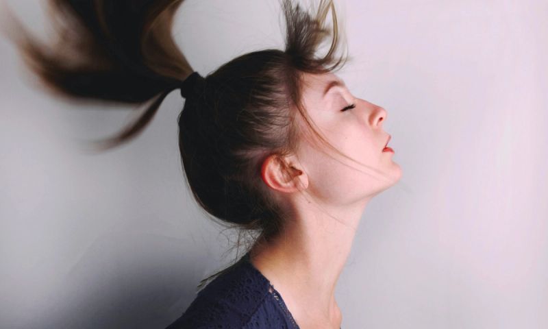Woman flipping over ponytail