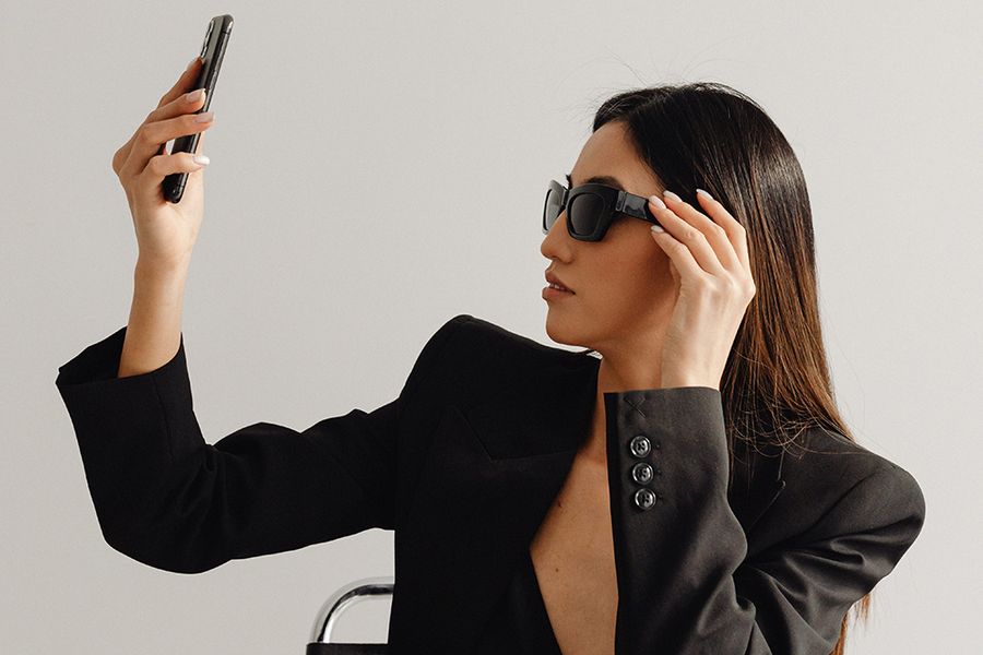woman in sunglasses taking a selfie