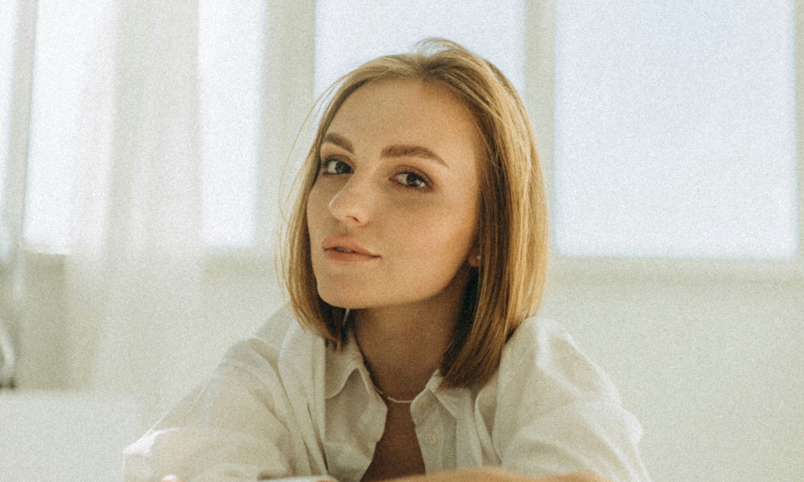 Woman with short hair in a white room