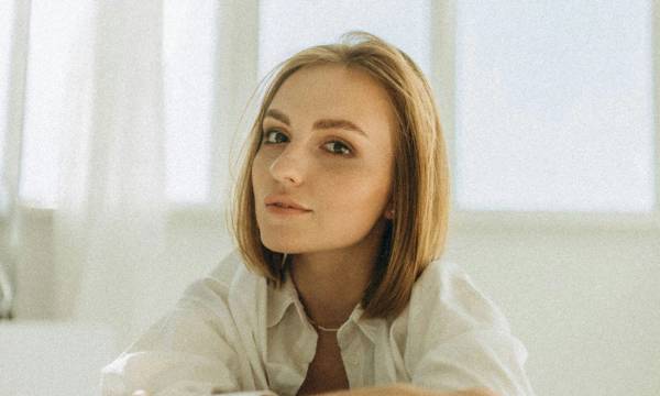 Woman with short hair in a white room